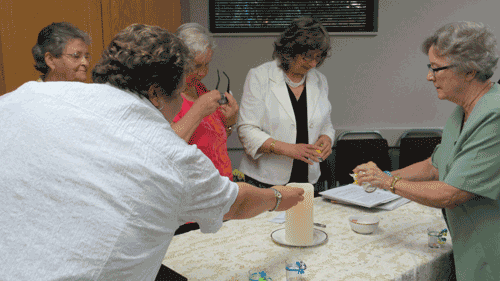 members lighting candles